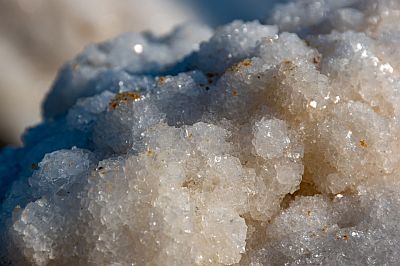 In Klumpen geballte rohe Salzkristalle liegen auf einem Haufen.